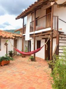 a house with a red hammock in front of it at la casa de la nona in San Gil
