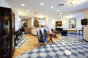 a lobby with chairs and a table and a bar at Punta Campanella Resort & Spa in Massa Lubrense