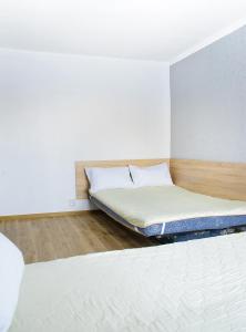 a bedroom with a bed in the corner of a room at Scandinavian Poltava Apartments with 2 rooms, 3 beds 1 sofa in Poltava