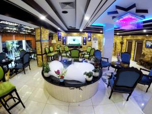 a salon with a waiting room with chairs and a tub at Petra Sella Hotel in Wadi Musa