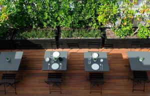 an overhead view of tables and chairs on a patio at The Modernist Thessaloniki in Thessaloniki