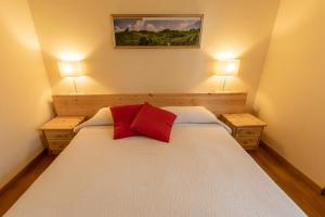 a bedroom with a large bed with two lamps on it at La Casa in Collina in Alba