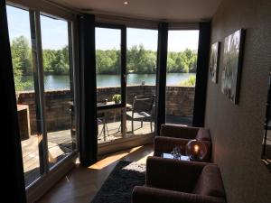 a living room with a view of a lake at Hotel Buenos in Geldrop