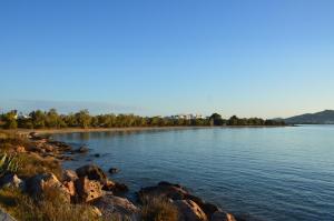 a large body of water with rocks and trees at ThalaSEA - village Antiparos in Antiparos
