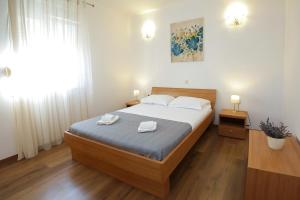 a bedroom with a bed with two towels on it at Villa Sena in Ražanj +44 photos