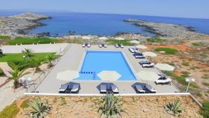 an aerial view of a resort with a swimming pool and the ocean at Nanakis Beach Apartments in Stavros
