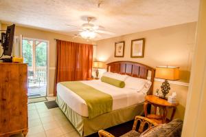 a bedroom with a large bed and a balcony at Asheville Cabins of Willow Winds in Asheville +173 photos