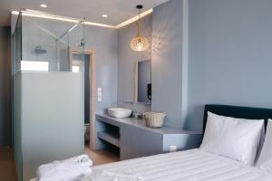 a bathroom with a white bed and a sink at Argilos in Sidari