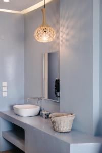 a bathroom with a sink and a mirror at Argilos in Sidari