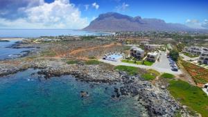 an aerial view of a resort and the ocean at Nanakis Beach Apartments in Stavros