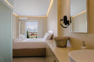 a bedroom with a bed and a window and a sink at Argilos in Sidari
