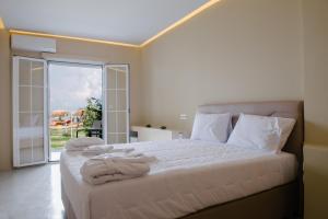 a bedroom with a bed with towels on it at Argilos in Sidari