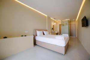 a hotel room with a bed and a television at Argilos in Sidari