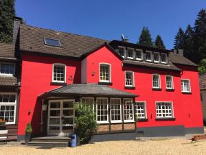 ハーゲンにあるWaldhotel Lembergの白窓のある大きな赤い建物