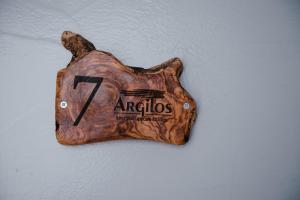 a sign shaped like a bear on a wall at Argilos in Sidari