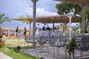 a group of chairs sitting under a pavilion at Argilos in Sidari