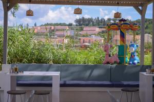 a bench in a restaurant with a view of a city at Argilos in Sidari