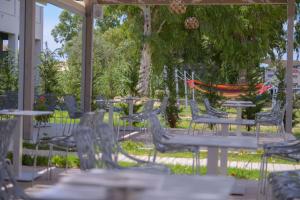 a group of chairs and tables in a yard at Argilos in Sidari