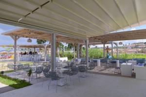 a group of tables and chairs under a pavilion at Argilos in Sidari