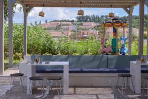 a table and chairs with a view of a playground at Argilos in Sidari