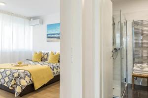 a bedroom with a bed and a shower at Relax & Recharge SEA VIEW Apartment in Split