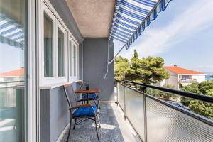 a balcony with two chairs and a table at Relax & Recharge SEA VIEW Apartment in Split