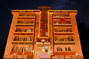 a hotel facade at night with the lights on at Figen Hotel in Çanakkale
