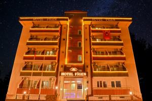 una fachada de hotel por la noche con las luces encendidas en Figen Hotel, en Canakkale