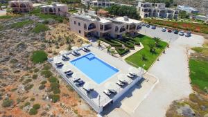 an aerial view of a house with a swimming pool at Nanakis Beach Apartments in Stavros