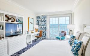 a living room with a tv and a large window at Isla Bella Beach Resort & Spa - Florida Keys in Marathon