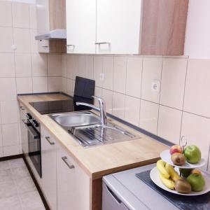 a kitchen with a sink and a plate of fruit at Nina in Zadar