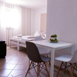 a room with a bed and a table and chairs at Nina in Zadar