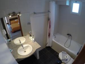 a bathroom with a sink and a bath tub at Kalias Hotel in Vasiliki