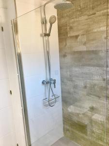 a shower in a bathroom with a glass door at Levante Apartment by Albir Proper Properties in Albir
