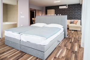 1 dormitorio con 1 cama grande en una habitación en Unicorniselit Apartmanok, en Eger