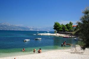 a group of people in the water at a beach at Apartments Villa Bayview in Trogir