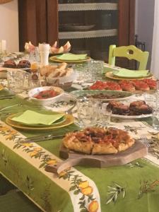 a long table with plates of food on it at Ciuci's Manor in Aragona +62 photos