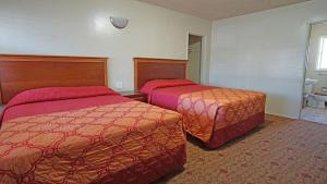 a hotel room with two beds and a bathroom at Rosa Bell Motel - Los Angeles in Los Angeles