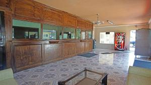 a large room with wooden cabinets and a refrigerator at Los Angeles Inn & Suites - LAX in Los Angeles