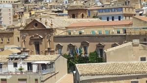 
a large building with a clock on the side of it at B&B La Casa Di El in Agrigento
