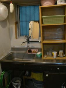 a sink in a kitchen with a counter top at Guest House Green House in Naha