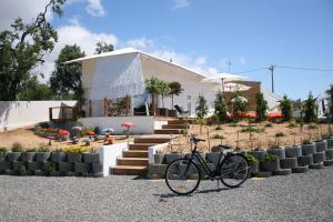 uma bicicleta estacionada em frente a uma casa em VILAPURA - Naturism em Tavira