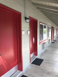 a row of red doors on the side of a building at Budget Inn -Yreka in Yreka