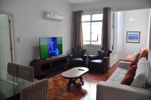 a living room with a couch and a tv at Apartamento Barao da Torre 85 in Rio de Janeiro