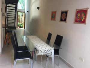 a glass table and chairs in a room at Madre Natura in Asuncion