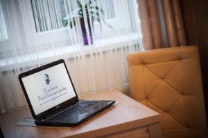 a laptop computer sitting on top of a wooden table at Rezydencja Pod Ochorowiczówką B&B in Wisła