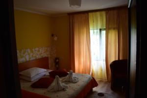 a bedroom with a bed with towels on it at Vila Tudor Mamaia Nord in Mamaia Nord