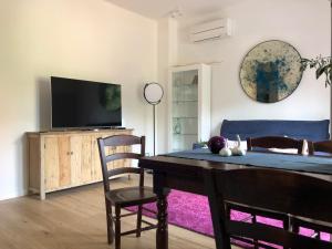 a living room with a table and a tv at Fantastic Luxury Apartments in Lerici in Lerici