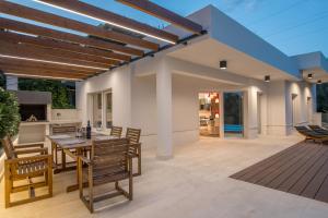 an open patio with a table and chairs on a deck at Luxury apartment Shelena in Mravince
