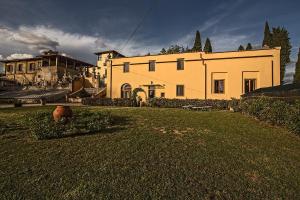 a large yellow building with a yard in front of it at Armonie di Villa Incontri B&B in Florence